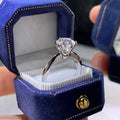 White gold-plated women's ring with six-claw setting holding geometric zircon stones