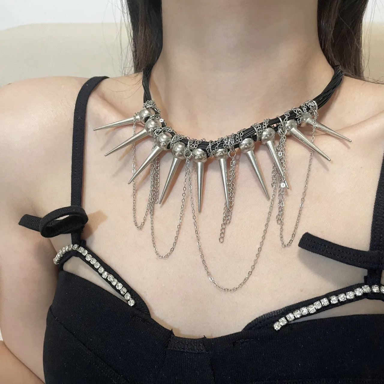 Women's leather necklace with electroplated round beads and a tassel drop in a casual, winding design.
