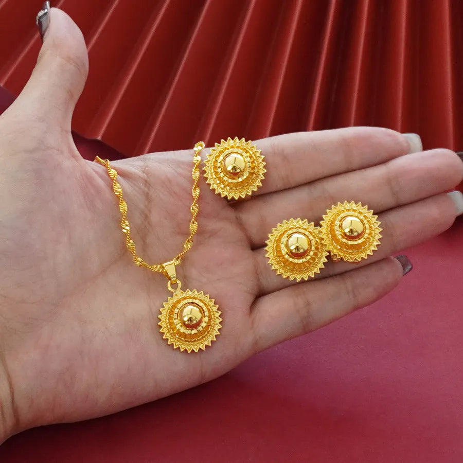 Three-piece gold electroplated jewellery set showing necklace with pendant, earrings, and matching ring
