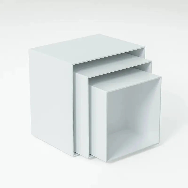 Six white plastic cube dessert display stands in graduated sizes from 3 to 8 centimetres.