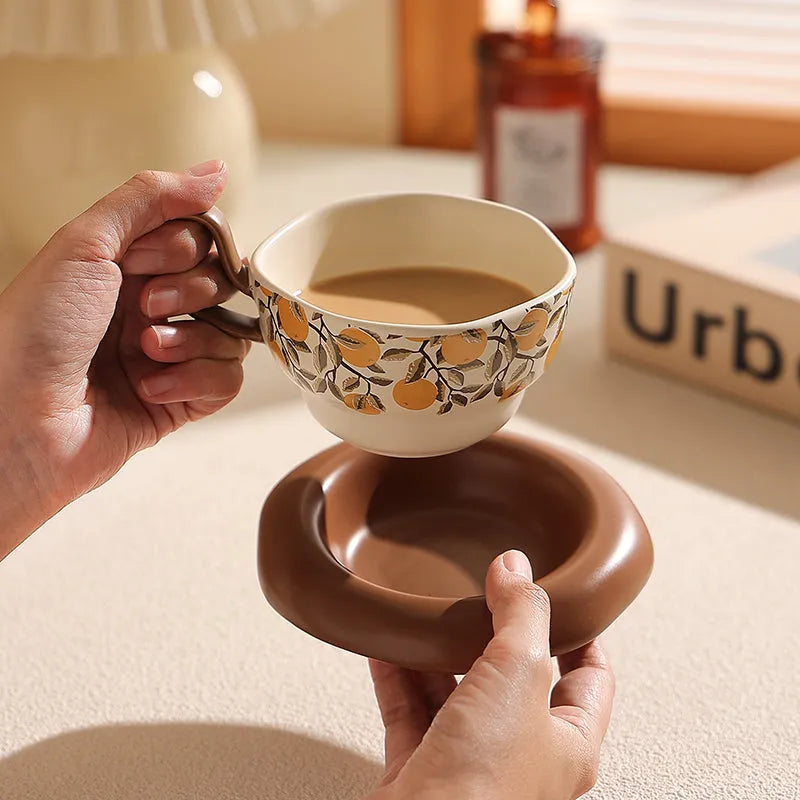 Antique style ceramic coffee cup and saucer set with medieval design in black or orange colour
