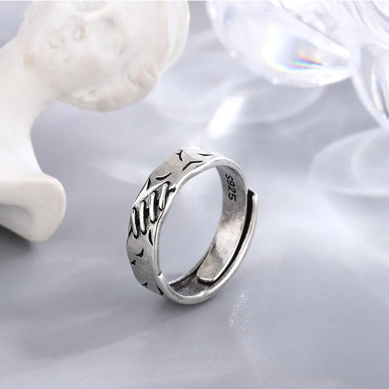 Black copper geometric ring with adjustable opening and round oval design elements