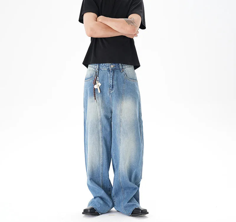 Light blue vintage washed wide leg machete jeans with a straight fit and zipper fly on a model.