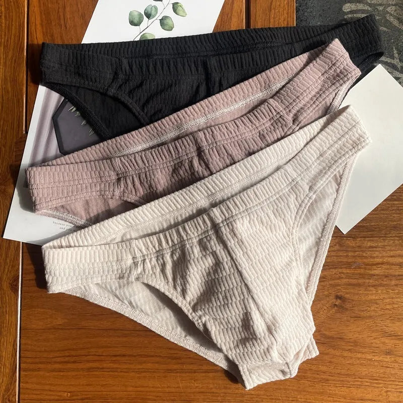 Men's solid colour cotton triangle underwear briefs with mid waistband, shown in apricot black colour.