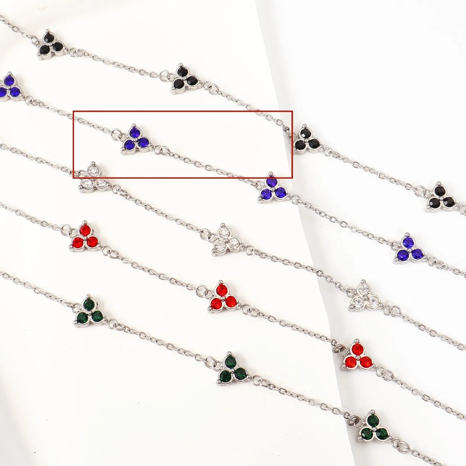 Women's stainless steel geometric triangle bracelet with a three-diamond pattern, shown in a gold and white zircon colour option.