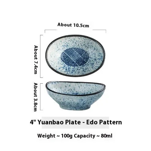Japanese ceramic oval sauce dipping bowl with traditional underglaze pattern on white background