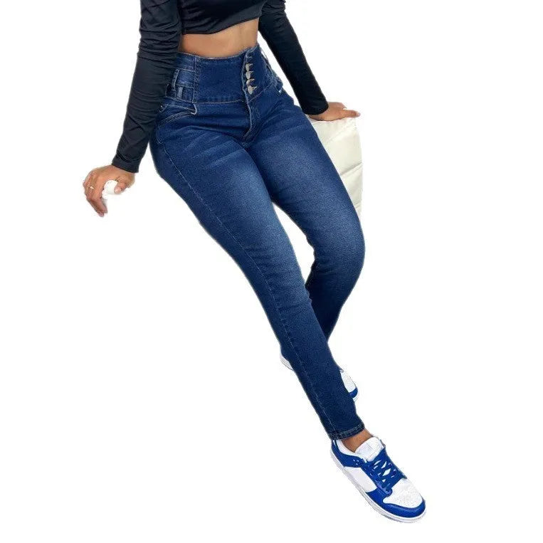 Dark blue women's straight-leg skinny denim trousers with zipper and button detail on a hanger.
