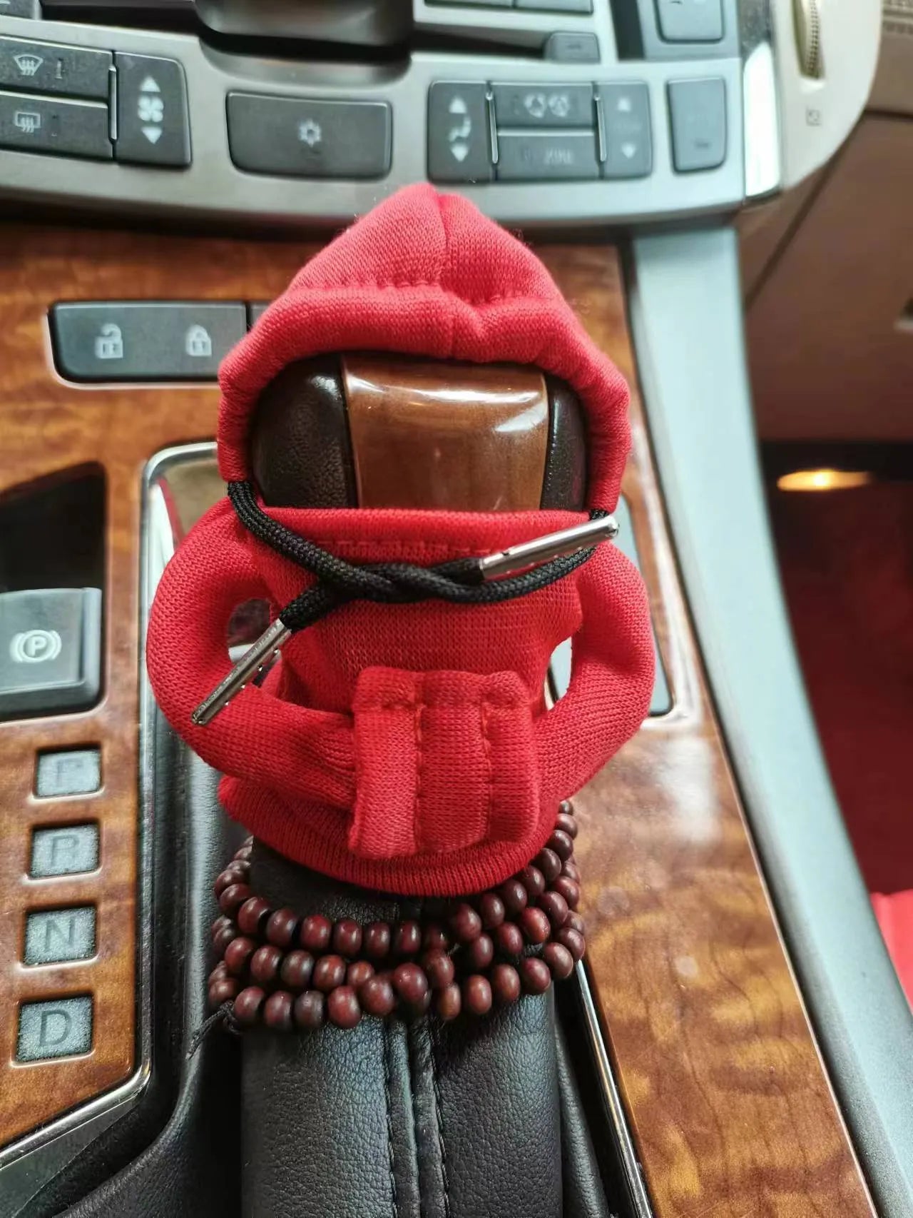 Soft Dutch velvet car gear handle cover in multiple colours on a gear stick.