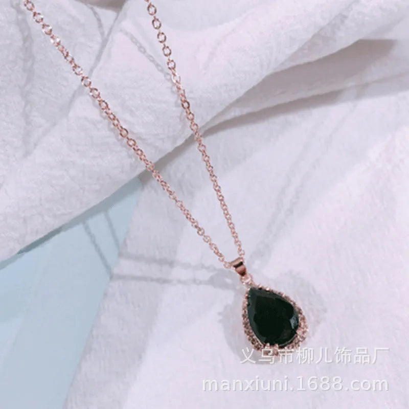 Pink water drop geometric necklace with rose gold electroplating and rhinestone detailing on alloy pendant