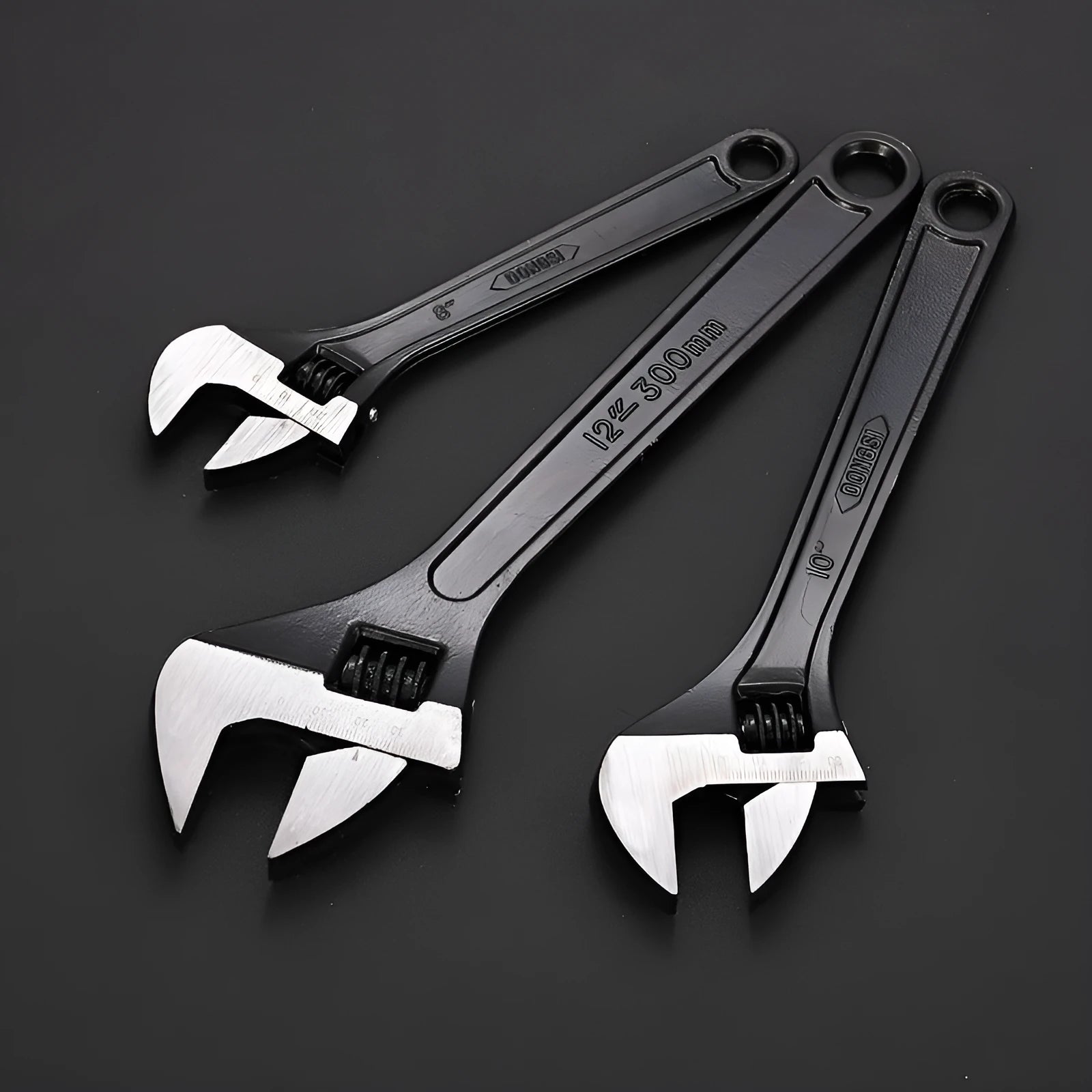 Stainless steel adjustable open-end wrench with blackened finish showing adjustment mechanism and four size options