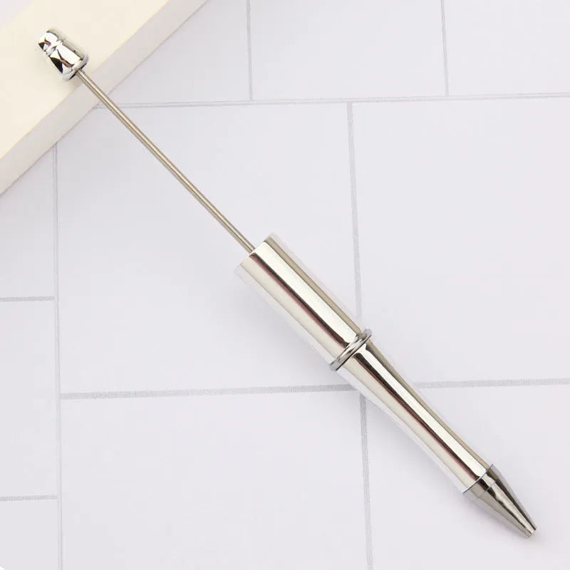Creative ballpoint pen with multicoloured spinning plastic beads on a steel wire frame.