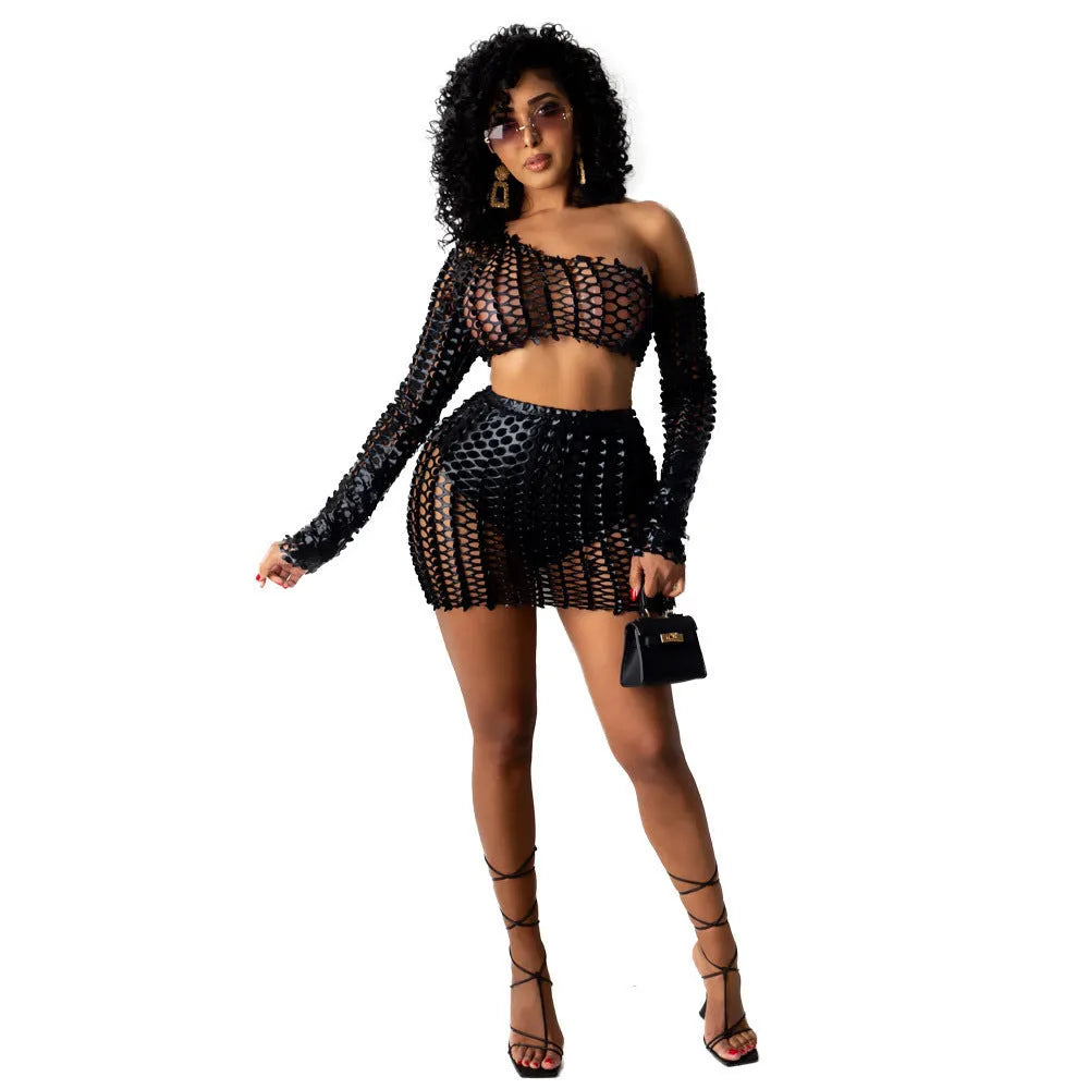 Women's black hollow-out two-piece set featuring a sleeveless top and short skirt with splicing detail.