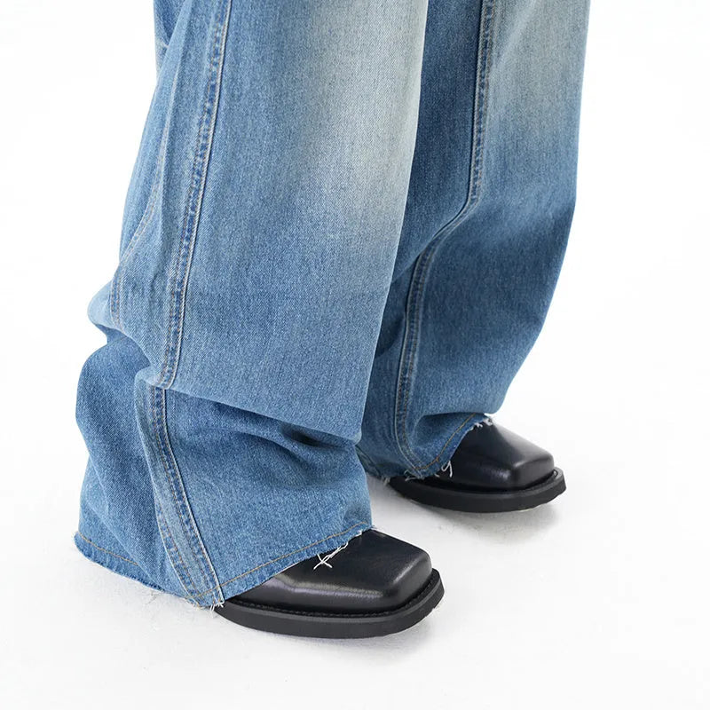 Light blue vintage washed wide leg machete jeans with a straight fit and zipper fly on a model.