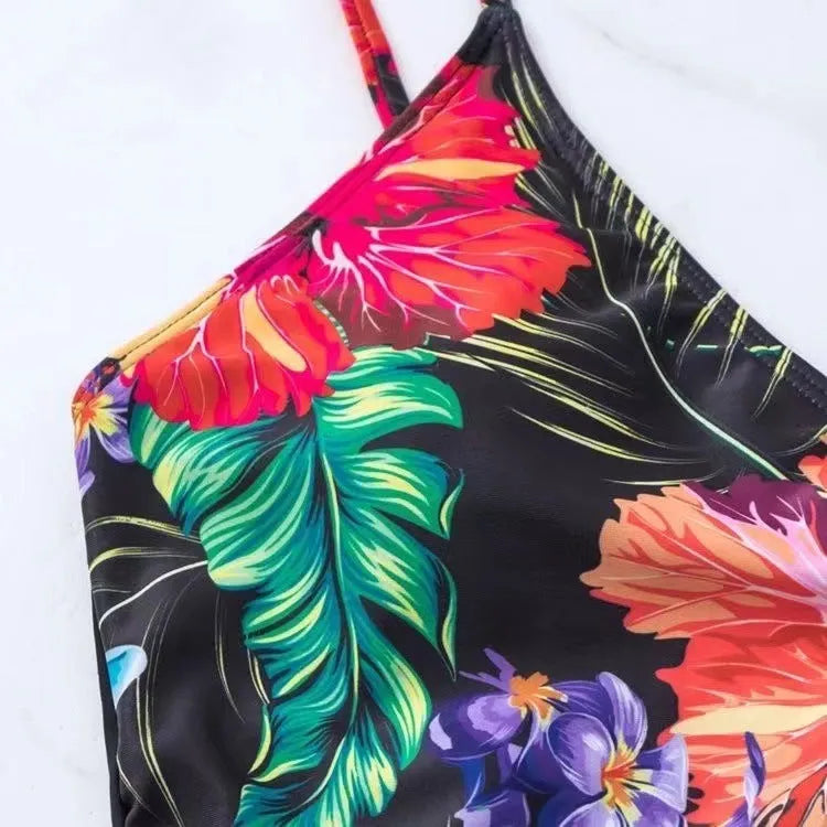 Black women's high-waist bikini briefs with a printed split design on a mannequin.