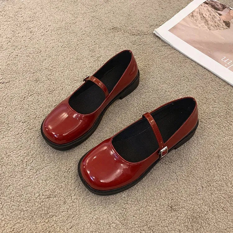 Women's solid colour flat heel loafers in red, black, or greyish black.