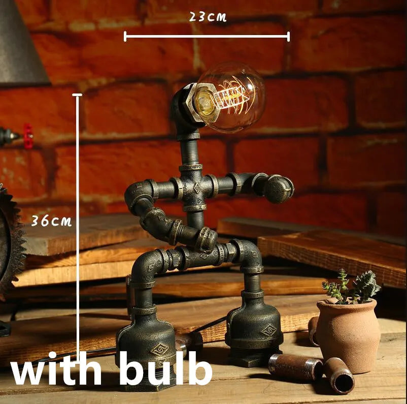 Green bronze vintage industrial robot desk lamp with iron pipe design on a wooden table.