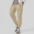 Men's grey casual tapered sweatpants with an elasticated waistband laid flat.
