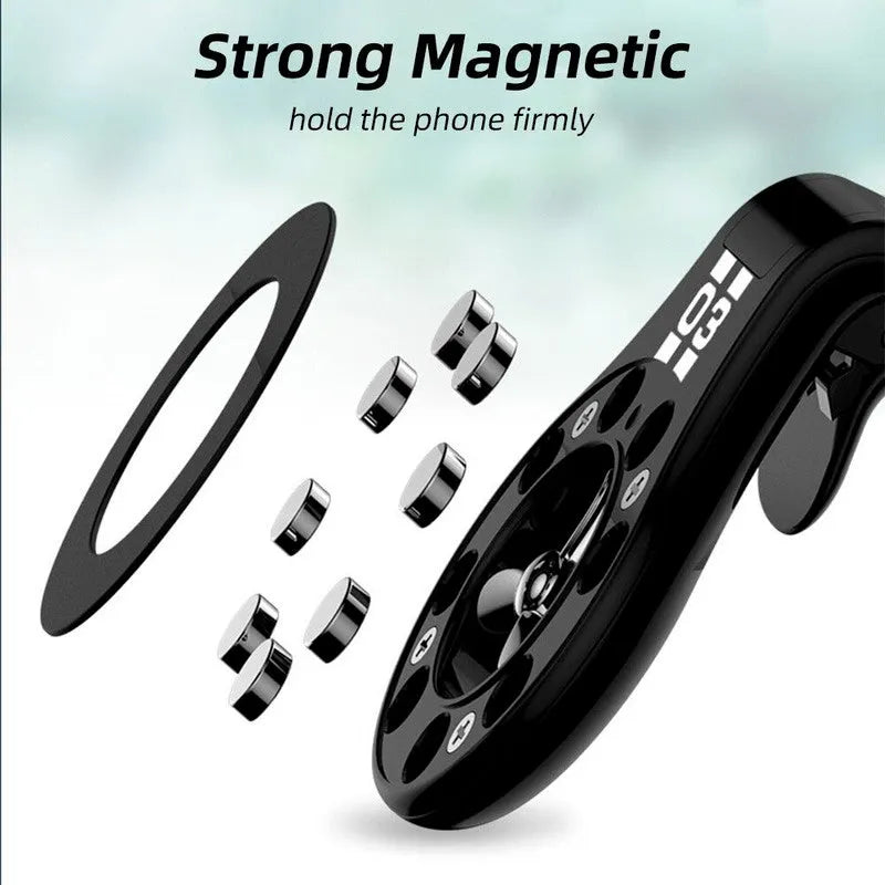 Black magnetic car phone holder clipped to a car air vent, showing a smartphone attached and the included fragrance slice.