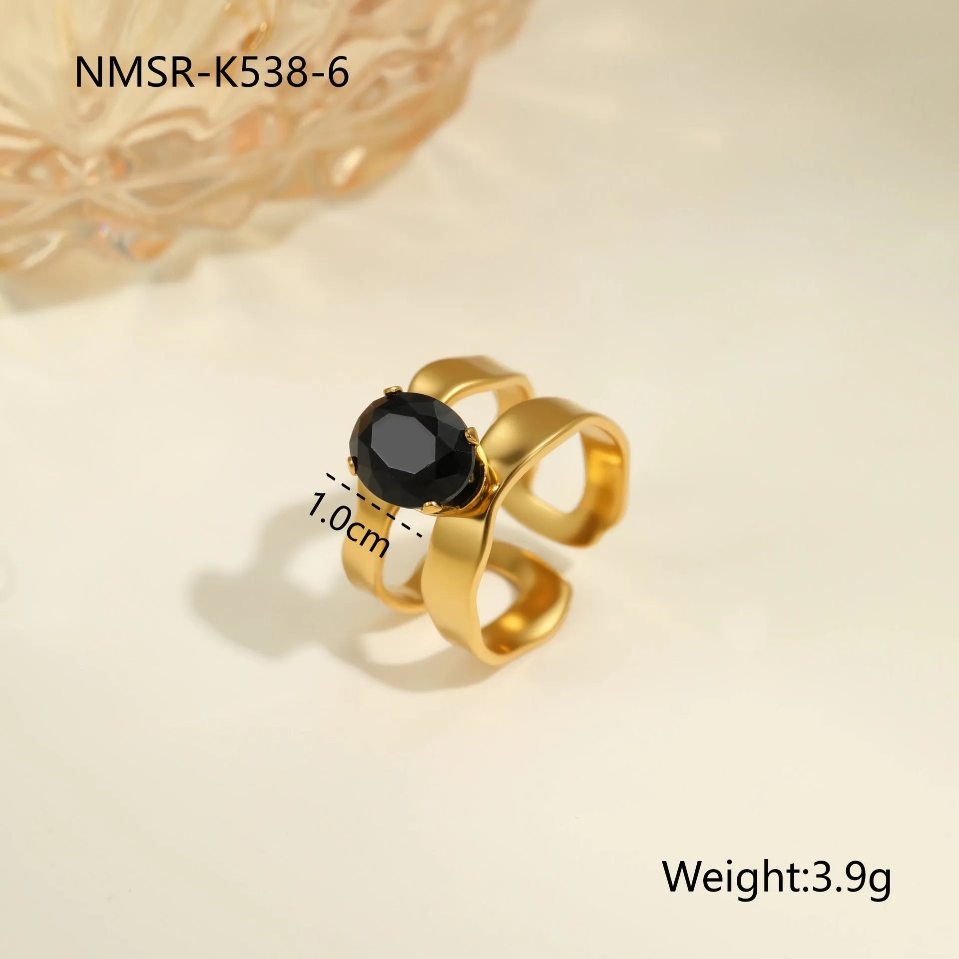 Geometric open mouth titanium steel ring for women on a plain background.