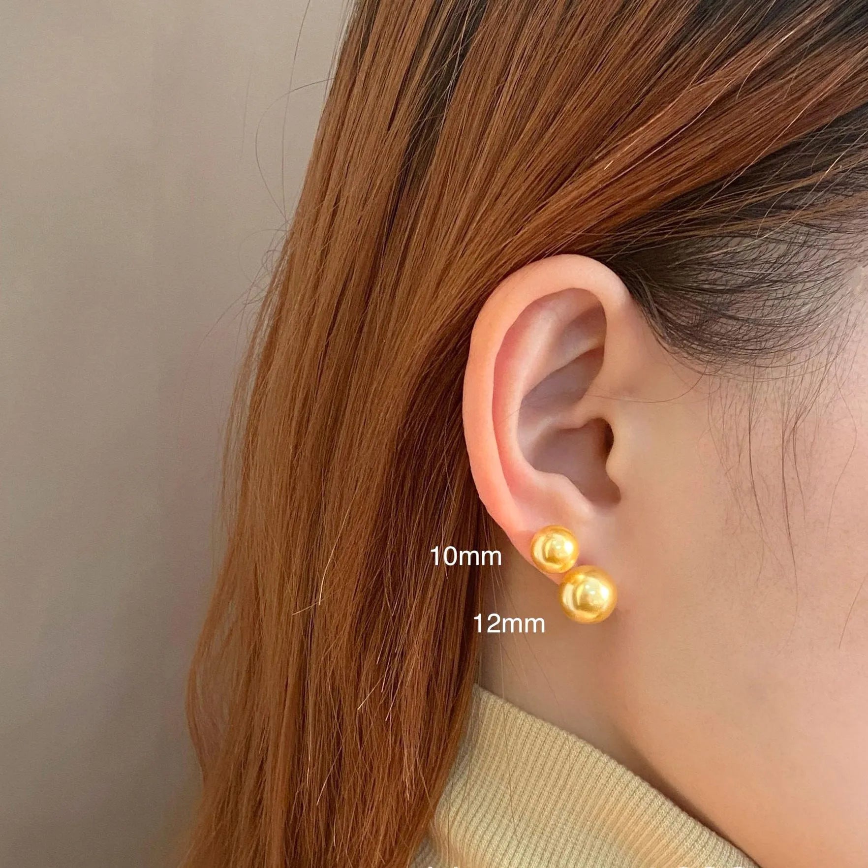 A pair of large geometric pearl stud earrings with a retro eight awn star motif on a silver setting.