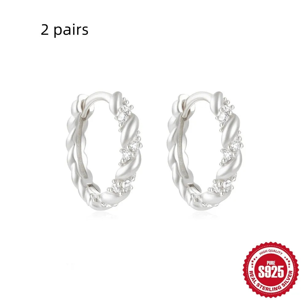 Sterling silver geometric stud earrings with small round diamond detailing in gold and silver electroplated finishes