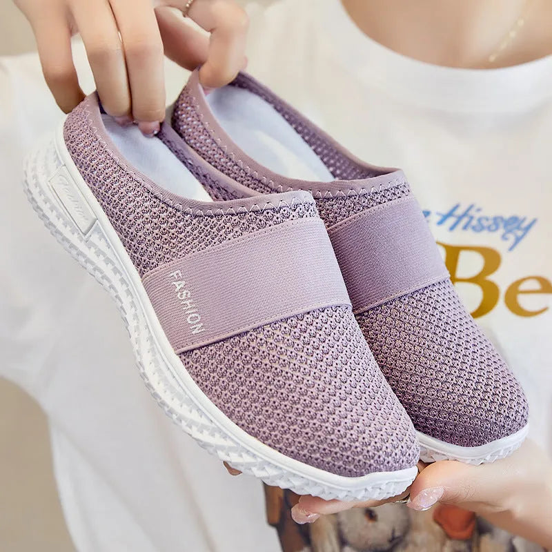 Women's flat-heel casual shoes in mesh material, showing round toe and hollow-out design in black colour.