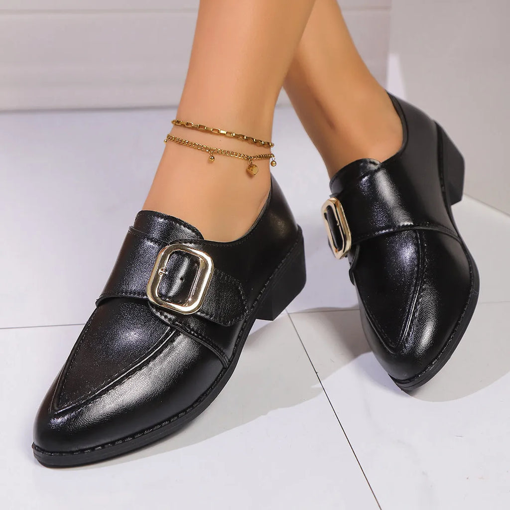 Women's brown leather-look shoes with a decorative bow detail on a flat rubber sole