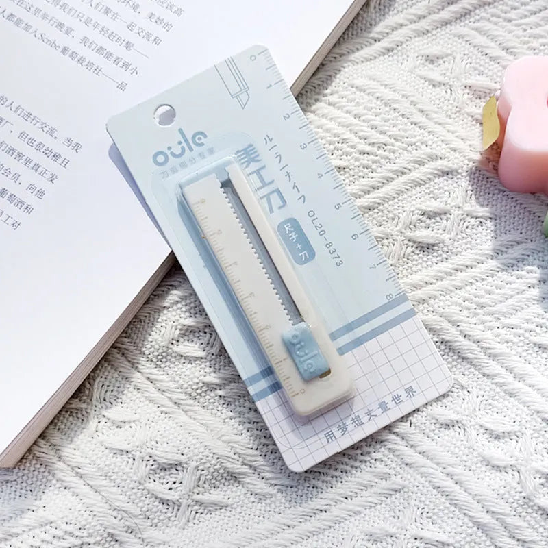 Small plastic-bladed art knife in blue, shown next to a ruler indicating its 7.2cm length.