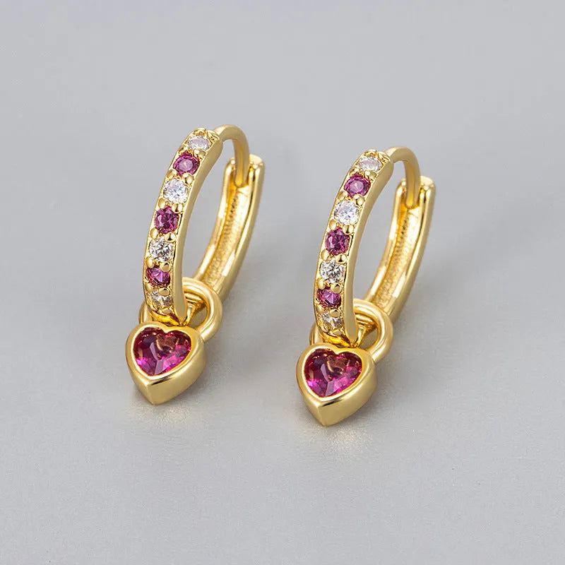 Women's fashion earrings with heart-shaped drops containing coloured gemstones in gold or white gold colour settings