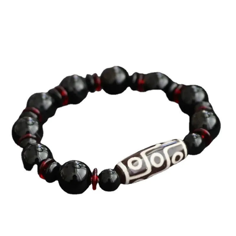 Hand-woven black agate dzi bead bracelet with geometry pattern on wrist