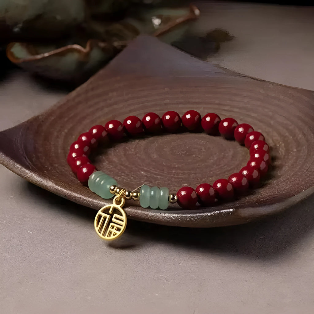 Gold cinnabar and copper bead bracelet in a wave shape on a wrist.