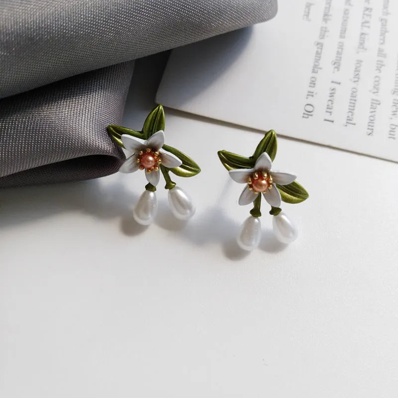 Sterling silver needle camellia earrings with flower ear clip design and contrast colour detailing