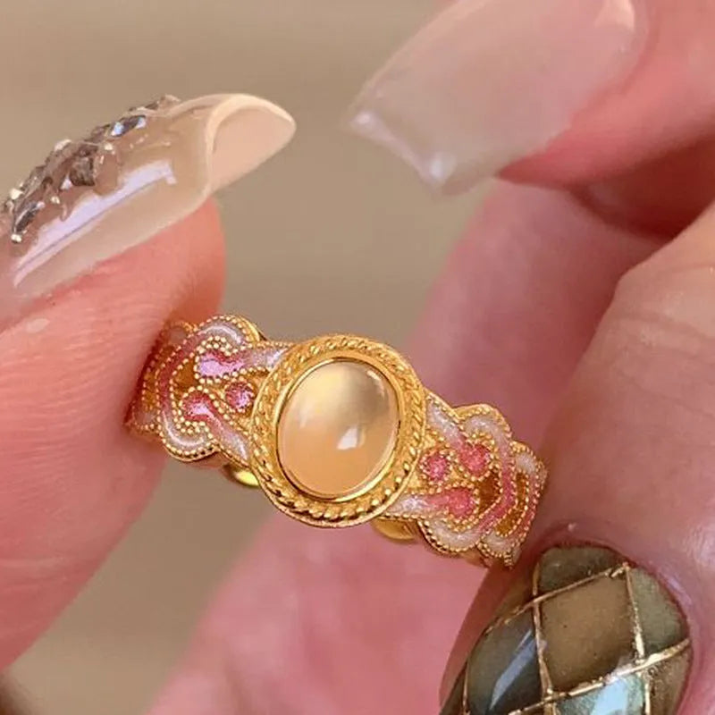 Geometric pink crystal enamel open ring for women on a copper band with gold plating.
