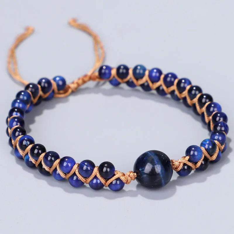 Handmade woven bracelet with geometric pattern in blue tigereye stone beads and pull closure.