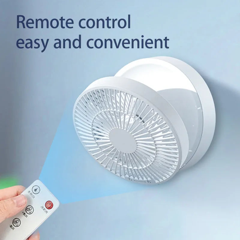 White portable folding desk fan with remote control and warm night light on a table