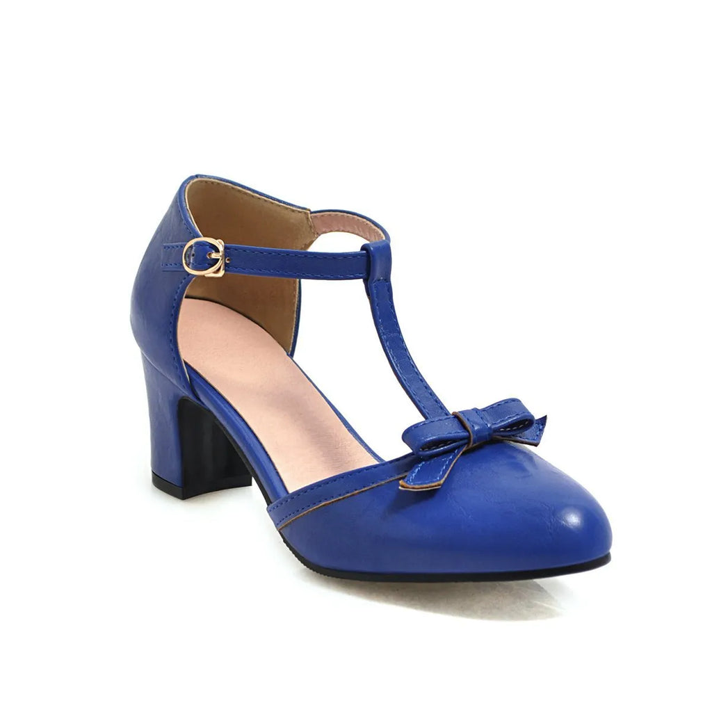 Yellow women's sandals with a buckle strap, chunky 6.5 cm heel, hollow-out pattern, and a bow tie.