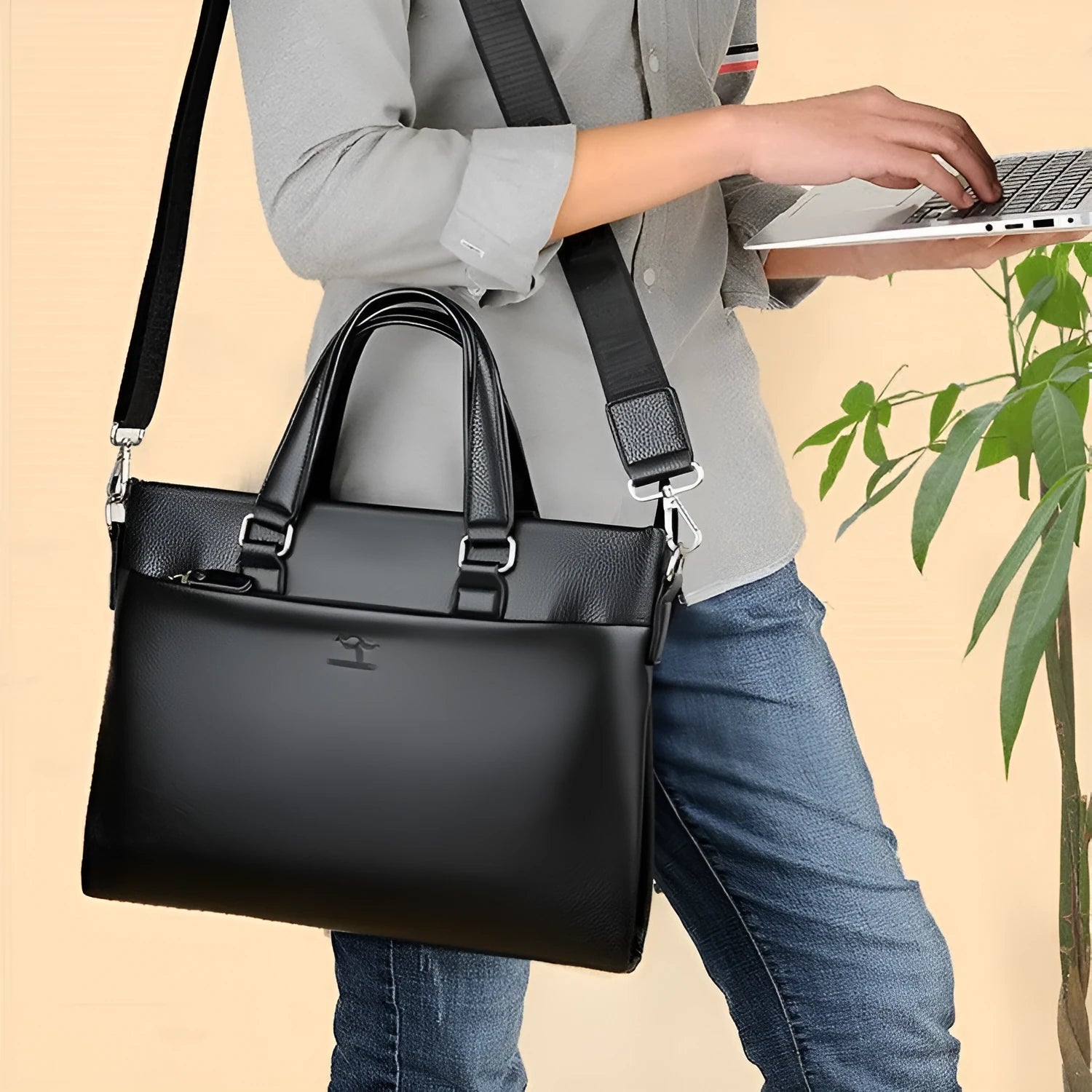 Men's black PU leather messenger bag with crossbody strap showing splicing design detail
