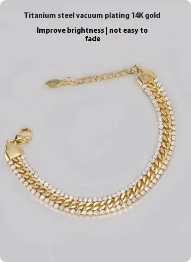 Gold-coloured tennis bracelet with gemstone detail on a titanium steel band.