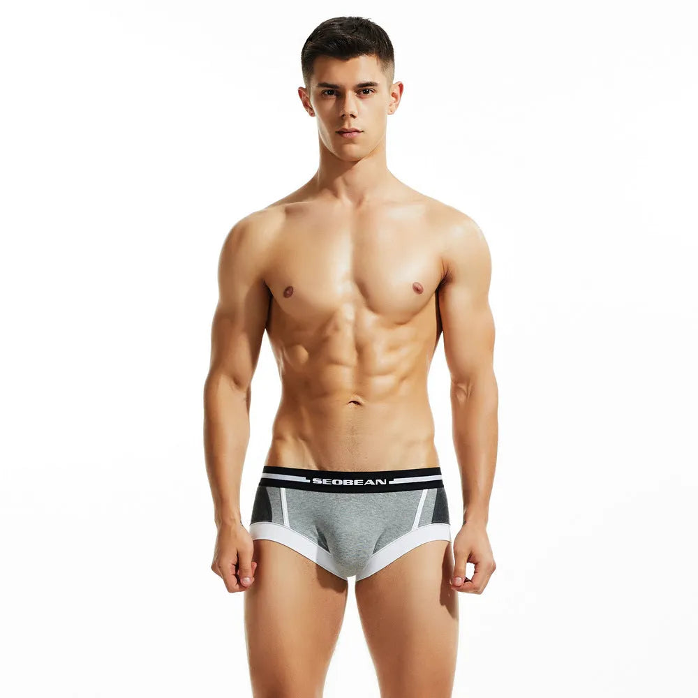 Men's low waist cotton boxer shorts in red, dark blue, or light grey, showing the hip-lifting design.