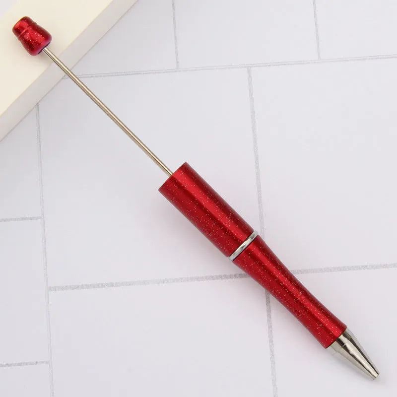Creative ballpoint pen with multicoloured spinning plastic beads on a steel wire frame.