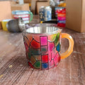 A decorative synthetic resin coffee cup ornament with a painted book design, shown in Library style.