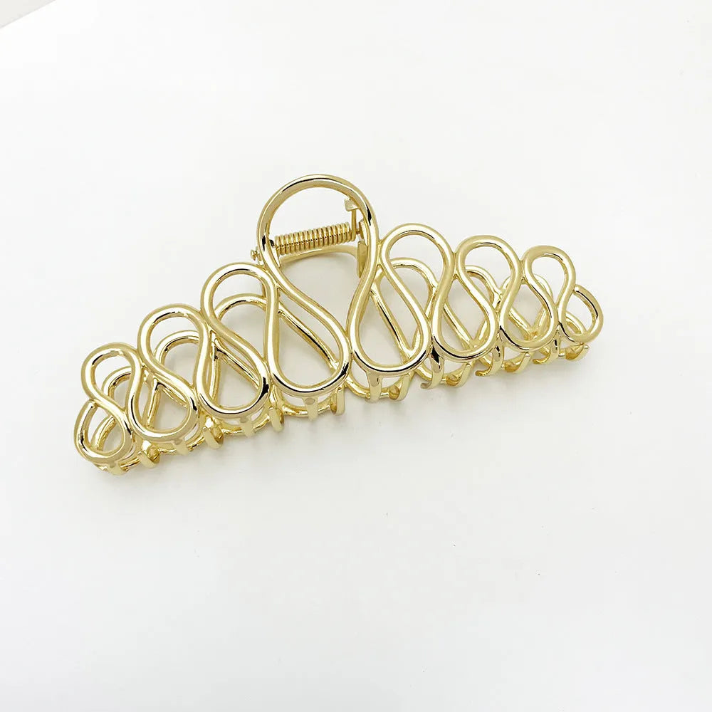 Large alloy hair clip with tassel design in gold electroplated finish for women's updo styling