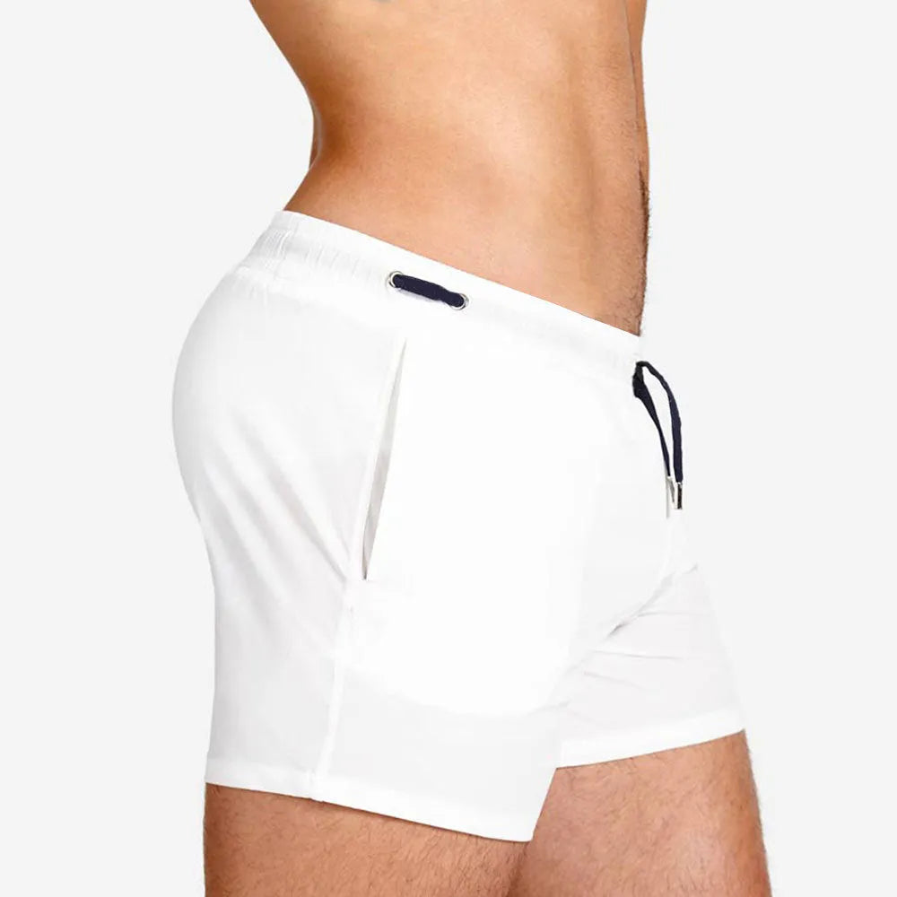 Men's solid colour swimming shorts with mesh lining for sports and fitness activities