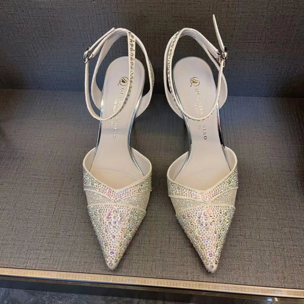 Women's black and silver hollow high heels with red stiletto soles and pointed toes.