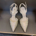 Women's black and silver hollow high heels with red stiletto soles and pointed toes.