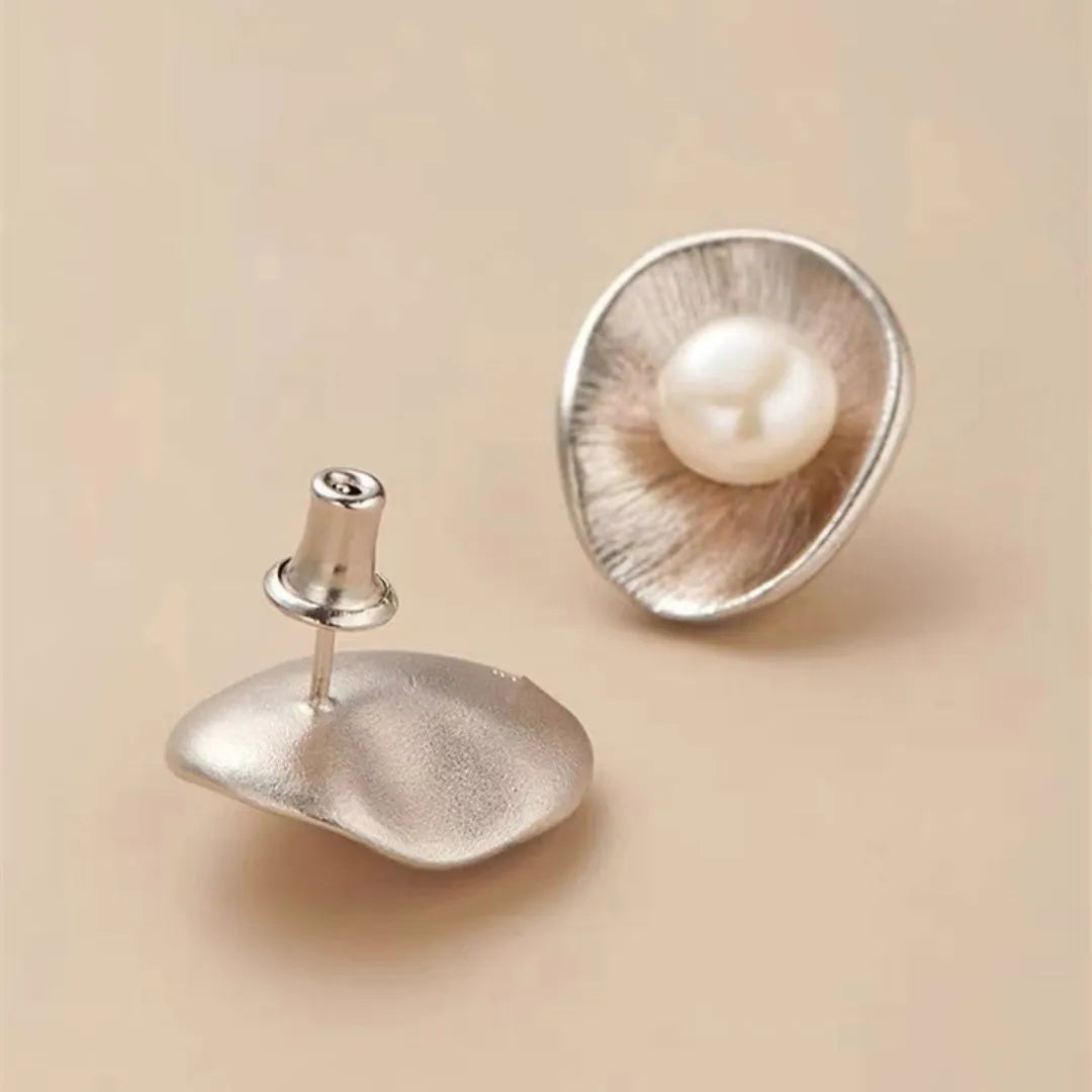 A pair of gold-coloured geometric sterling silver stud earrings featuring a single pearl.