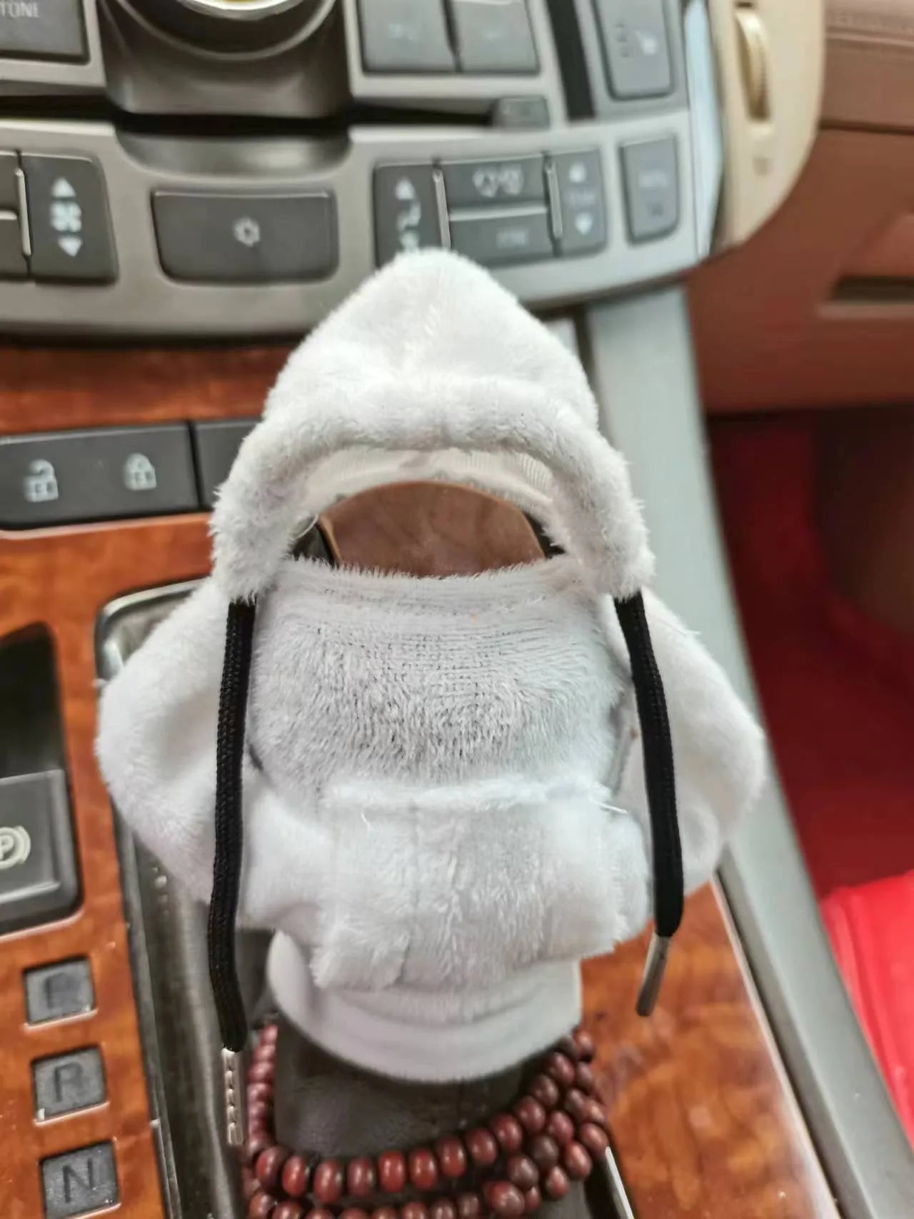 Soft Dutch velvet car gear handle cover in multiple colours on a gear stick.