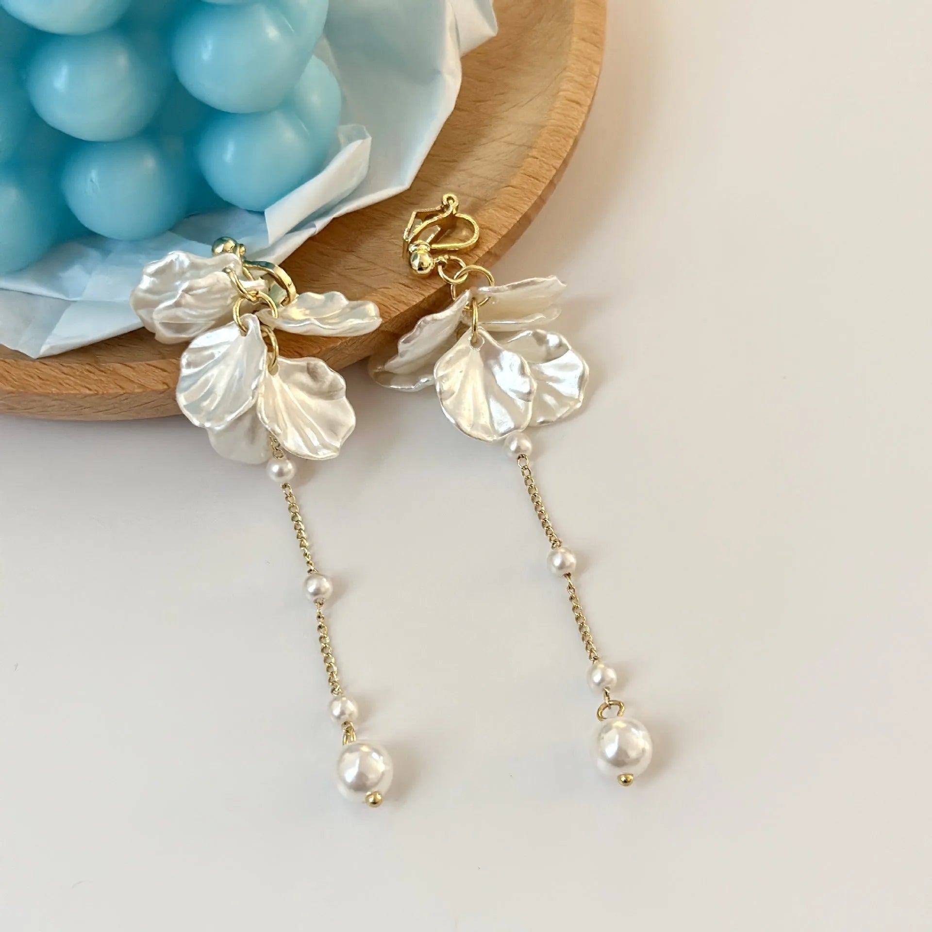 Women's acrylic shell pearl tassel earrings showing four different clip style options
