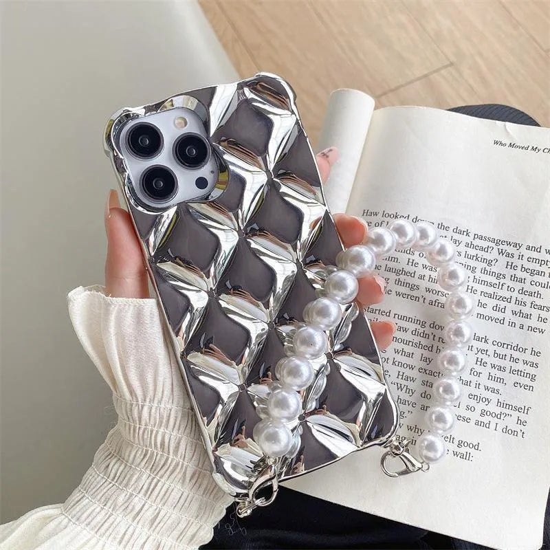 Gold diamond bracelet attached by chain to a TPU phone case for iPhone.