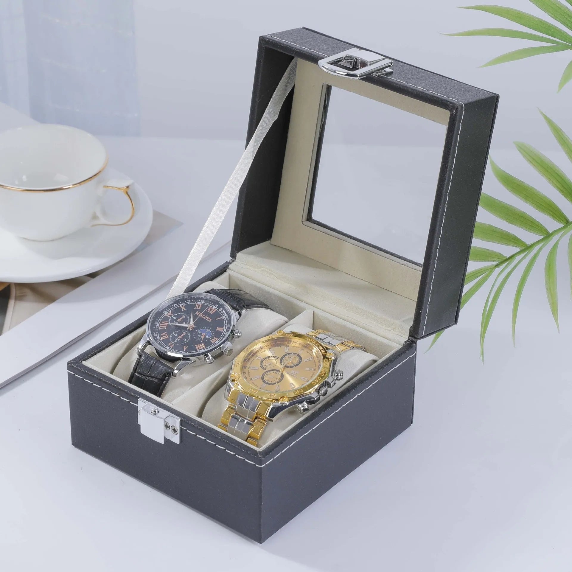 Grey leather watch storage box with transparent lid showing multiple watch slots inside